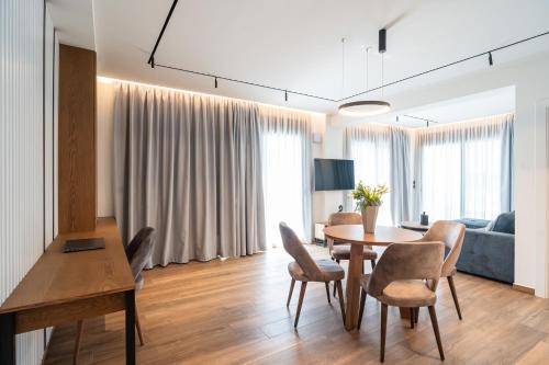 a living room with a table and chairs at Volos Inn Hotel in Volos