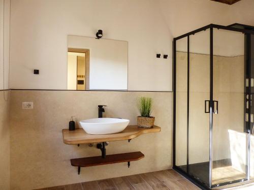 a bathroom with a sink and a mirror at Struttura Monte Olimpo in Porto Torres