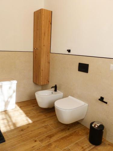 a bathroom with a white toilet and a sink at Struttura Monte Olimpo in Porto Torres