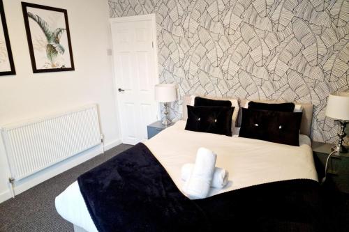 a bedroom with a large bed with two pillows at Fantastic Home! Football Fans -5 min to Stadium in Liverpool