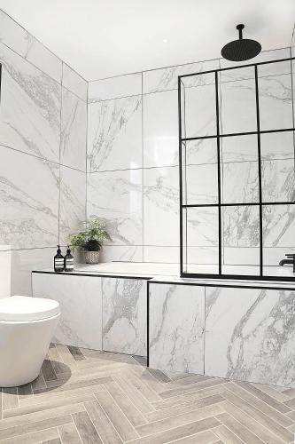 a white bathroom with a sink and a toilet at Newly refurbished home on the North Coast - AONB in Bushmills