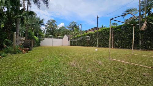 a dog standing in a yard with a goal at La Floresta - Cabañas con Naturaleza y Tranquilidad in Puerto Iguazú