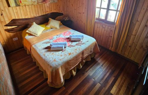 a bedroom with a bed in a wooden room at La Floresta - Cabañas con Naturaleza y Tranquilidad in Puerto Iguazú