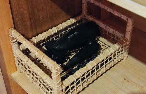 a basket full of wine bottles sitting on the floor at La Floresta - Cabañas con Naturaleza y Tranquilidad in Puerto Iguazú