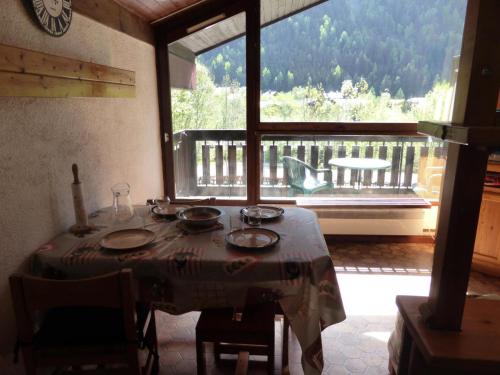 - une table dans une chambre avec vue sur un balcon dans l'établissement Résidence Mont'seu - Mont'seu C401 MAE-6354, aux Contamines-Montjoie