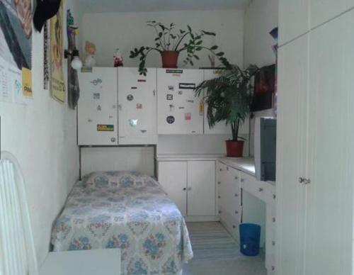 a kitchen with white cabinets and a table in it at 1, 2 or 3 Bed Rooms - Malta Central Location, Very near Sea and Tourism hub in Msida