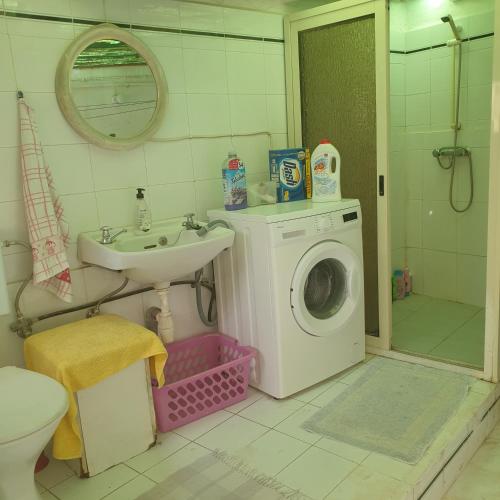 a bathroom with a washing machine and a sink at 1, 2 or 3 Bed Rooms - Malta Central Location, Very near Sea and Tourism hub in Msida