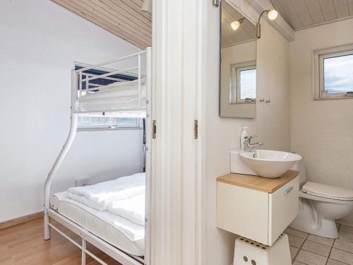 a bathroom with a bunk bed with a sink and a toilet at 4 star holiday home in Ansager-By Traum in Ansager