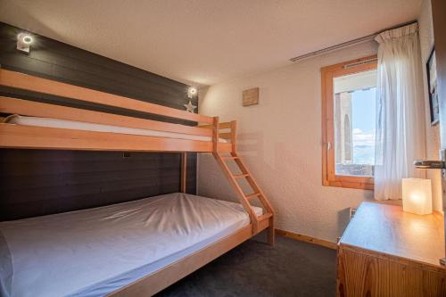 a bedroom with two bunk beds and a window at PIERRAFORT G - Appartement PIERRAFORT 19 pour 5 Personnes 20 in Valmorel