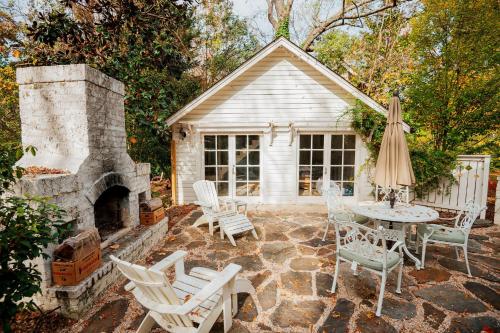 a patio with a fireplace and a table and chairs at The Cinderella House in Greensboro