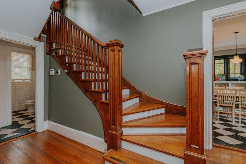a wooden staircase in a home with aoyer at The Cinderella House in Greensboro