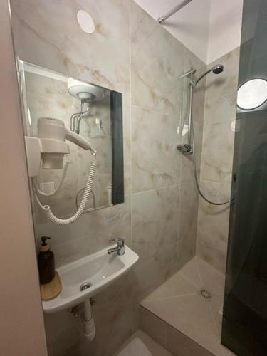 a bathroom with a shower and a sink at DATRI Petite Suite 8 in Vienna