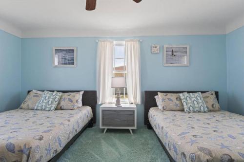a bedroom with two beds and a window at Quarter Deck Cottage on Flagler Beach in Flagler Beach