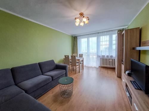 a living room with a couch and a table at Legnicka Budget Stay - Grysko Apartament's in Szczecin