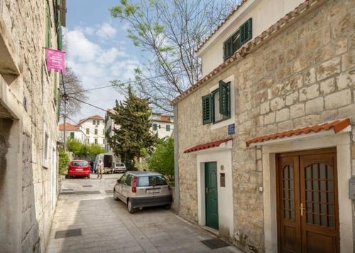 a car parked in a parking lot next to a building at Tarino Apartment in Split