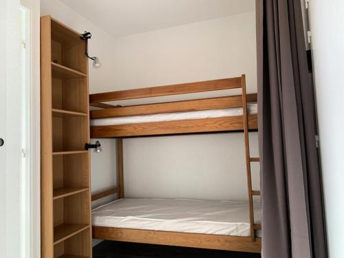 a room with two bunk beds and a closet at Résidence Royal Peyragudes Mp - T2/6pers -ROYAL 31B- Peyresourde MAE-2954 in Germ