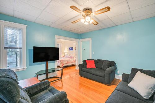 a living room with two couches and a flat screen tv at 5 Mi to Dtwn Boston! Family-Friendly Medford Apt in Medford