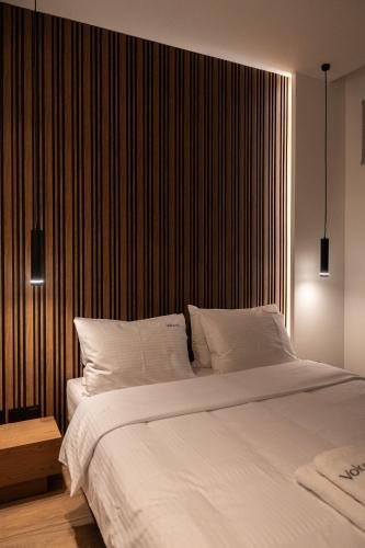 a bedroom with a large bed with white sheets at Volos Inn Hotel in Volos