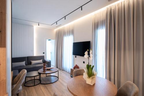 a living room with a table and a couch at Volos Inn Hotel in Volos