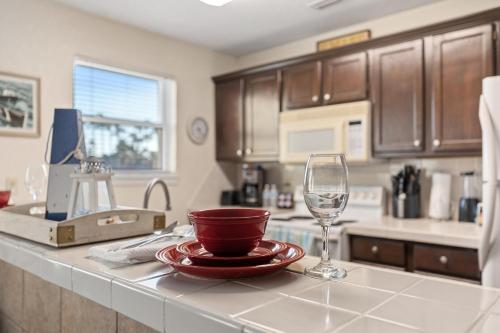 a kitchen with a counter with a wine glass at Coronado Get-AWAY at Fantasy Circle in South Padre Island
