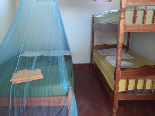 a bedroom with two bunk beds with a net at Playa Casa Nohelia in Santo Domingo