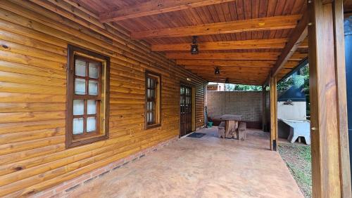 a porch of a wooden house with a bathroom at La Floresta - Cabañas con Naturaleza y Tranquilidad in Puerto Iguazú