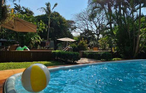 a swimming pool with an egg in the water at La Floresta - Cabañas con Naturaleza y Tranquilidad in Puerto Iguazú