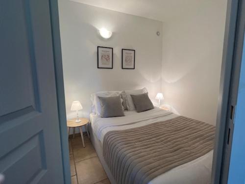um quarto com uma cama com dois candeeiros em DOMAINE LOU BEL AZUR - Charmant em Saint-Laurent-du-Var