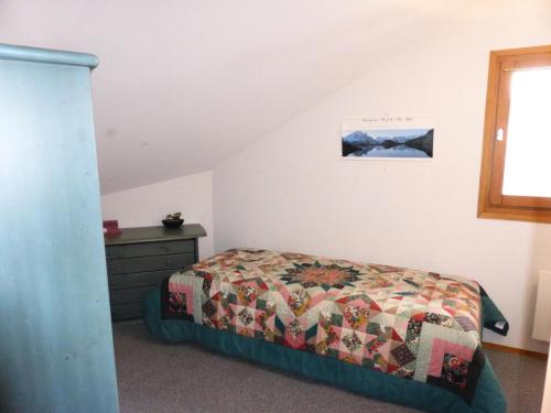 une chambre avec un lit avec une couette dessus dans l'établissement Résidence L'enclave - Enclave I652 MAE-3414, aux Contamines-Montjoie