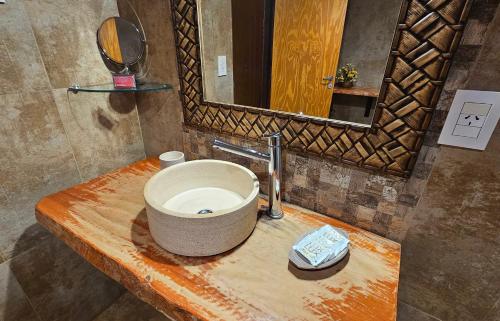 a bathroom sink with a bowl on top of it at La Floresta - Cabañas con Naturaleza y Tranquilidad in Puerto Iguazú