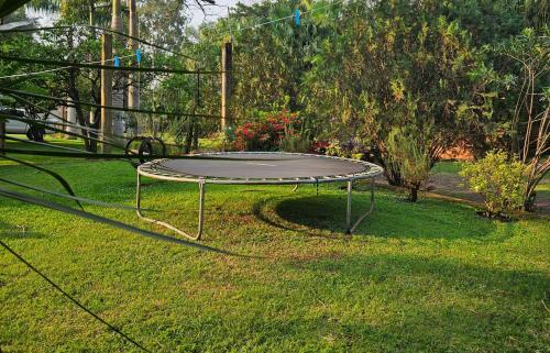 a trampoline sitting on the grass in a yard at La Floresta - Cabañas con Naturaleza y Tranquilidad in Puerto Iguazú