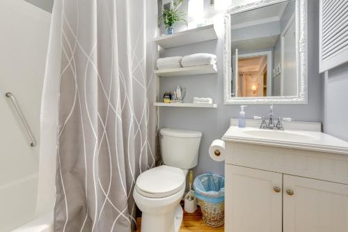 a bathroom with a toilet and a sink and a mirror at Breezy Tybee Island Condo - 100 Yards from Beach! in Tybee Island