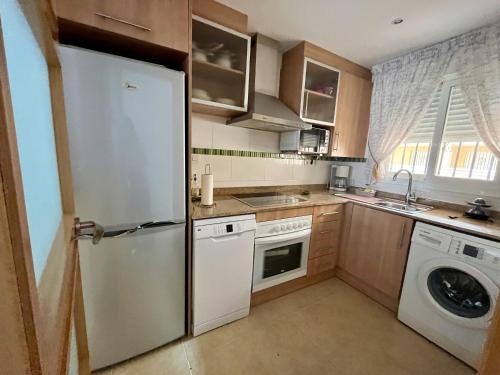 a kitchen with a refrigerator and a washer and dryer at Valparaiso8 in Oropesa del Mar