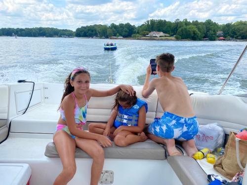 una mujer y dos niños sentados en un barco en Wet anchor Tours en Charlotte