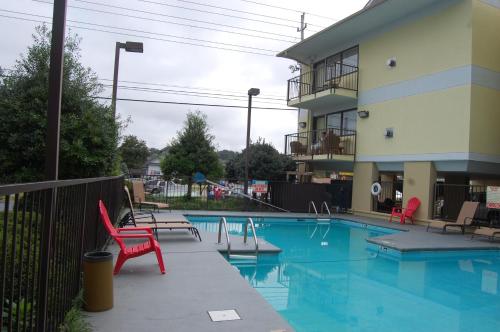 a swimming pool in front of a apartment building at Vacation Lodge in Pigeon Forge
