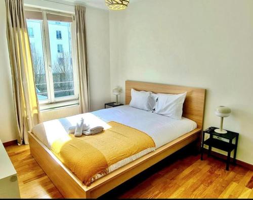 a bedroom with a large bed with a yellow blanket at Luxury one bedroom flat with parking&balcony-Cent2 in Luxembourg