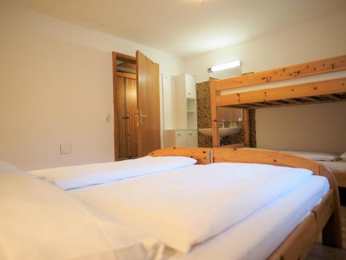 two beds in a room with two bunk beds at Berghof Burtscher in Ludesch