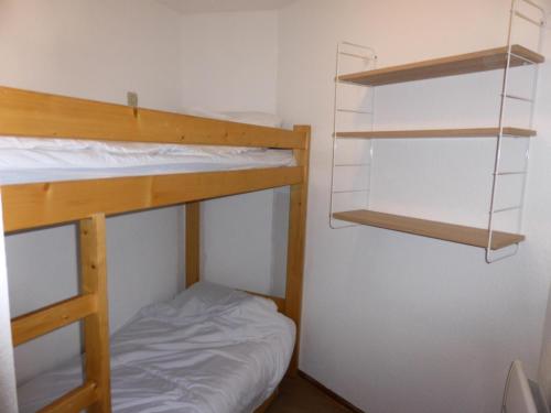 a small room with two bunk beds and a bed at Résidence Combettes - Studio pour 4 Personnes 071 in Les Contamines-Montjoie