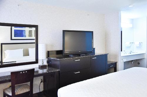 a hotel room with a television and a desk with a bed at Argo Inn and Suites in Idaho Springs