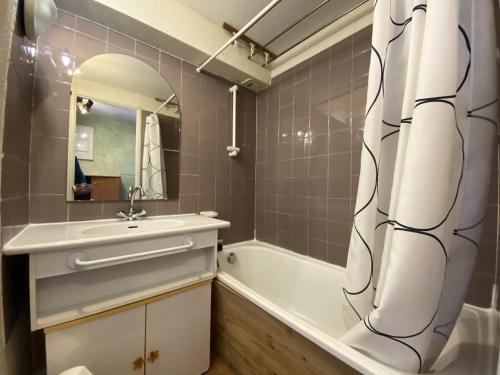 une salle de bain avec un lavabo, une baignoire et un miroir dans l'établissement Résidence Silveralp - VAL THORENS location: Proche garderie et école de ski, appartement 4 pers avec mezzanine MAE-9083, à Val Thorens