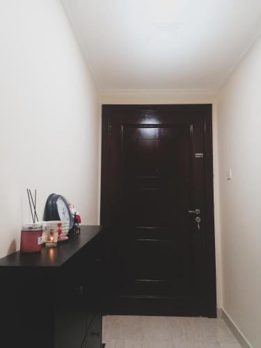 eine schwarze Tür in einem Zimmer mit schwarzer Theke in der Unterkunft Roomstay Abu Dhabi in Abu Dhabi