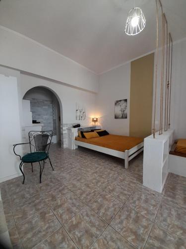 a bedroom with a bed and a chair in it at Overhill Apartments Adamas in Adamantas
