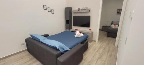 a bedroom with a bed with a blue blanket at Erre Home in Naples