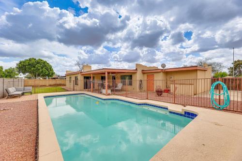 a swimming pool in front of a house at Private Pool and Patio Home Near Mesa Arts Center! in Mesa