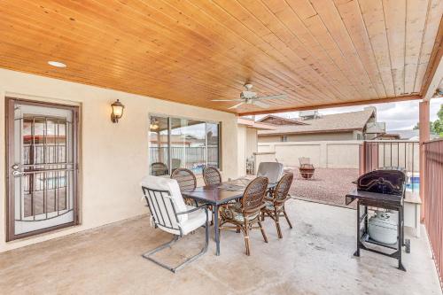 a dining room with a table and chairs on a patio at Private Pool and Patio Home Near Mesa Arts Center! in Mesa