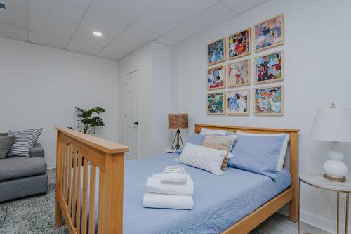 a bedroom with a bed with blue sheets and pillows at Marys Gatehouse Garden Apartment in Greensboro