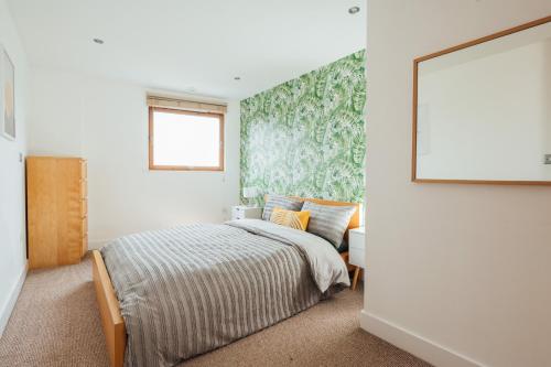 a bedroom with a bed and a large window at Leeds City Centre Dock 2 Bed 2 Bath in Hunslet
