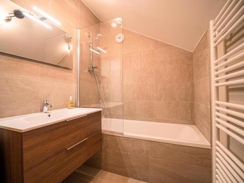 a bathroom with a sink and a shower and a tub at CHALET LUMI - Chalet CHALET MEIJE pour 6 Personnes 094 in Valmorel