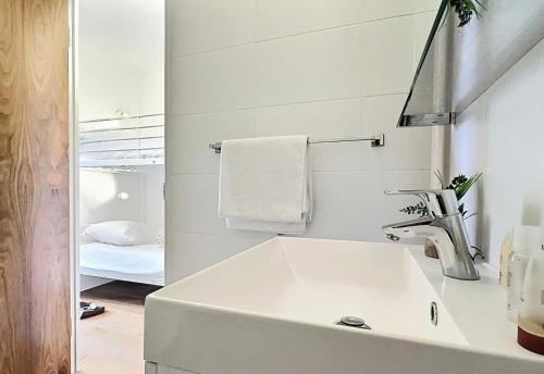a white bathroom with a sink and a mirror at Résidence Home Club - Studio pour 4 Personnes 71 in Tignes