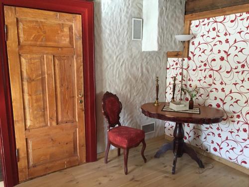 a room with a table and a chair and a door at Rosma Mill Holiday House in Põlva